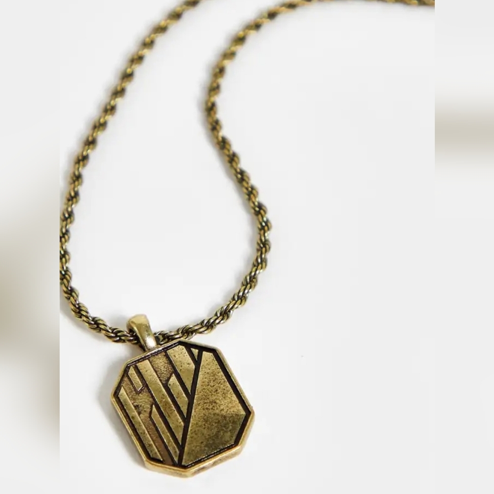 The Status Syndicate pendant with texture detail in burnished gold finish